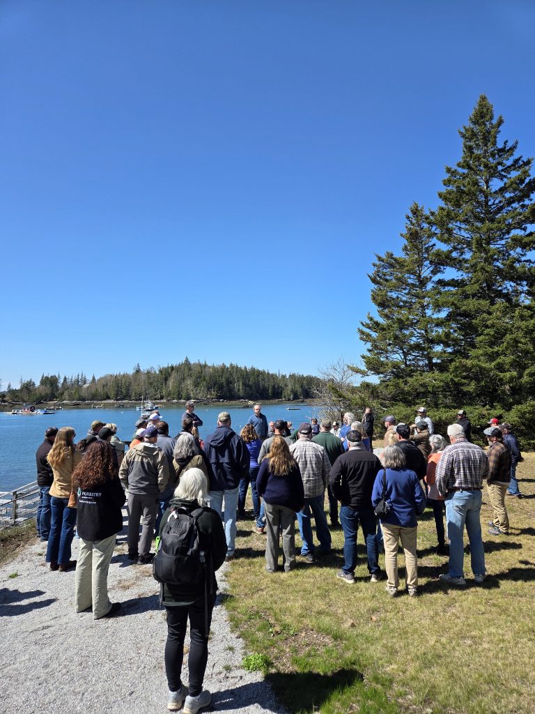 PLC members and supporting members learning about the Vinalhaven Land Trust on a beautiful sunny day